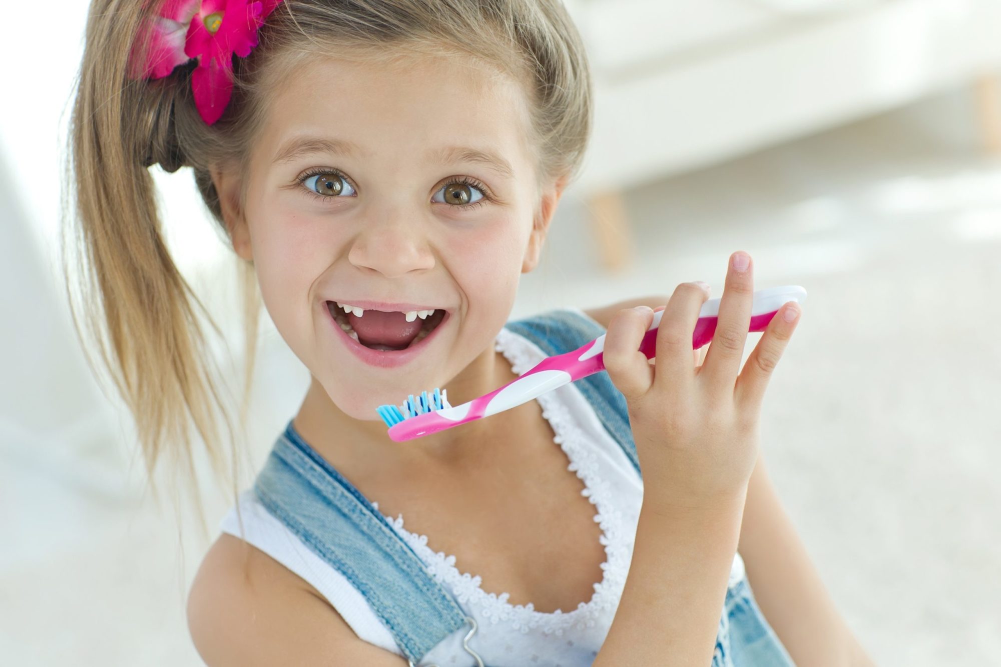 girl smiling with toothbrush